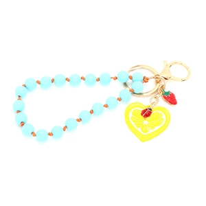 Handmade beaded keychain with strawberry and lemon charms on a white background
