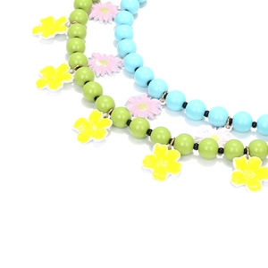 Detail of colorful beaded necklaces with enamel flower charms and golden metal accents