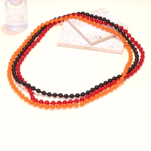 Handmade beaded necklace in vibrant orange, red, and black gradient beads for Halloween