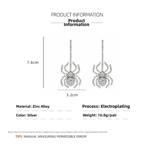 Detailed view of silver spider earrings with sparkling rhinestones and exact dimensions
