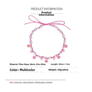 Detail of pink resin flowers and heart pendant on handmade bohemian beaded necklace