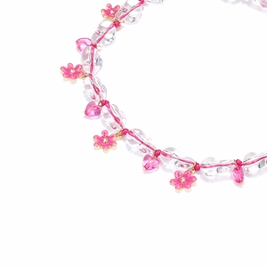 Detail of pink flower charms and heart beads on a beaded summer bohemian necklace