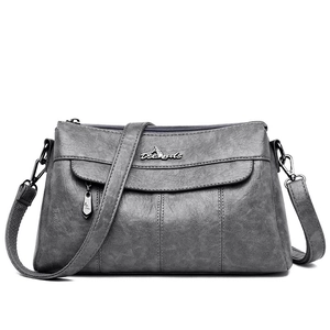 Deep grey leather crossbody bag with multiple zip compartments and adjustable strap