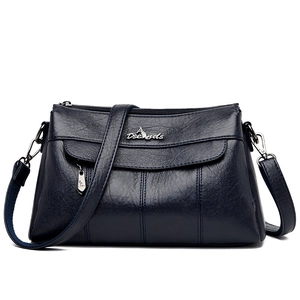 Women's dark blue soft faux leather crossbody bag with adjustable strap and metal logo