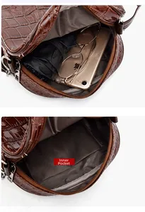 Detail view of the brown crocodile pattern bag showing inner patch pocket and storage capacity