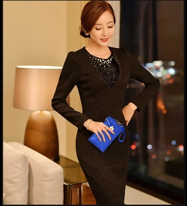 Detail of elegant black slim dress featuring pearl and sequin neckline embellishments