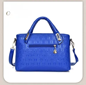 Rear view of blue PU leather handbag showing a zipper pocket and embossed oval pattern