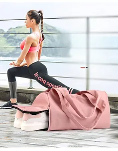 Pink fitness bag detail showing separate shoe compartment and water-resistant fabric