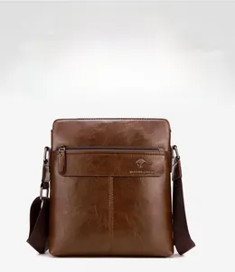 Close-up of brown leather messenger bag with embossed kangaroo logo and adjustable strap