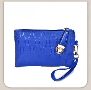 Close-up of royal blue envelope bag featuring textured chain pattern and gold zipper details