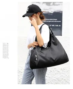 Detail of black sports tote bag featuring a separate shoe compartment and wet pocket