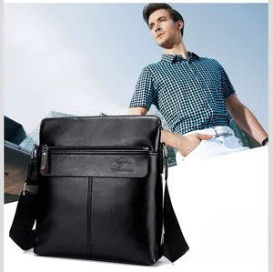 Detail of black pebbled leather vertical crossbody bag with adjustable wide shoulder strap