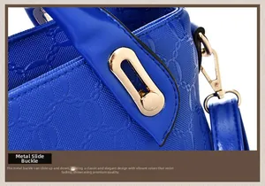 Close-up of royal blue handbag with golden sliding buckle and textured woven leather