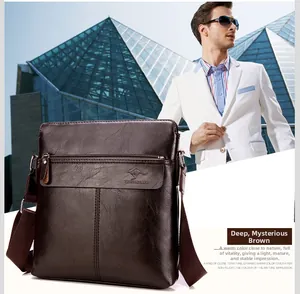 Detail of dark brown leather crossbody bag with adjustable strap and embossed logo