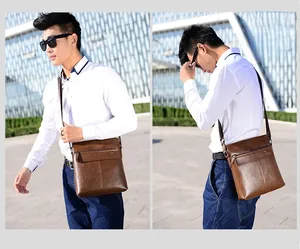 Close-up of a brown leather crossbody bag for men showing zipper pocket and flap details