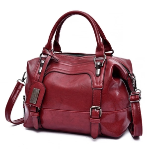 Deep red Boston bag in oil wax leather with top handles and detachable shoulder strap
