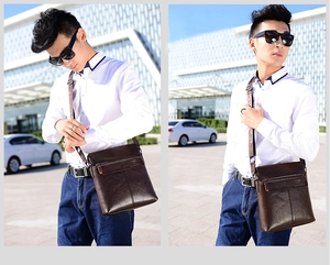 Deep brown vertical messenger bag with adjustable strap and embossed logo detail