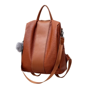 Brown faux leather women's backpack with gray faux fur pom-pom detail on white background