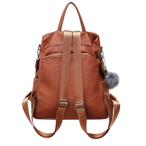 Brown lychee texture backpack with adjustable straps and grey faux fur pompom detail