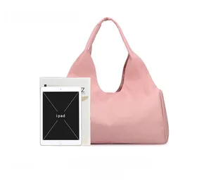 Pink large-capacity sports bag showing size comparison with iPad and A4 magazine