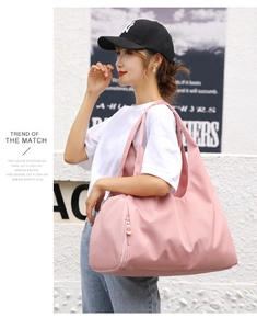 Pink waterproof fitness bag featuring a spacious side pocket for travel and sports