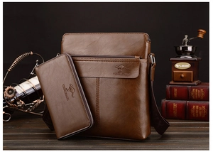 Close-up of brown leather men's shoulder bag and wallet set on a vintage desk