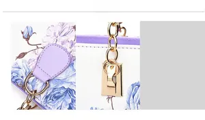 Detailed view of floral print texture and premium gold metal hardware on handbag