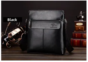 Detailed view of black vertical crossbody bag featuring embossed kangaroo logo and leather texture