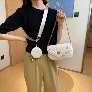 White quilted crossbody bag with gold chain strap and matching small round coin purse