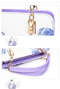 Detail of floral printed handbag with golden hardware and textured white leather