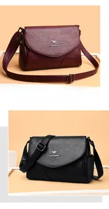 Détails de sacs à bandoulière en similicuir grainé bordeaux et noir avec logo kangourou