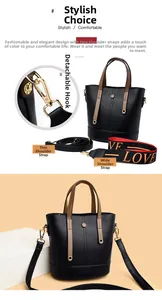 Detail of black bucket bag featuring two detachable straps and gold metal hooks