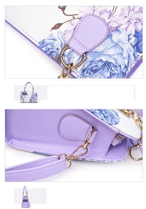 Detail of purple floral PU leather handbag with golden metal handles and crossgrain texture