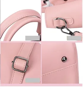 Detailansicht von rosa Henkeltasche mit Metallschnallen und Schutznieten am Boden