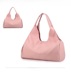 Pink gym tote bag made of lightweight nylon fabric with long handles for shoulder carry