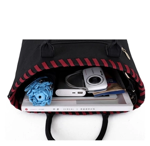 Top view of large black tote bag showing spacious interior and red woven edge details