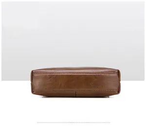 Detailed bottom view of khaki leather crossbody bag with neat stitching and smooth texture