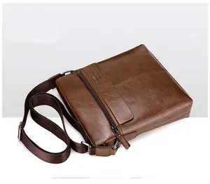 Detailed macro view of khaki leather texture and embossed kangaroo logo on vertical bag