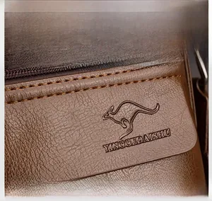 Close-up of brown litchi pattern leather bag with embossed kangaroo logo and stitching