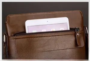 Detail of brown leather men's messenger bag with front zipper pocket for tablet storage