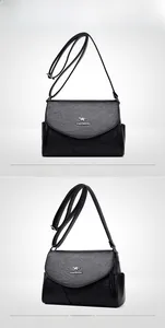 Vue de face et de côté d'un sac bandoulière noir en cuir avec logo de kangourou argenté