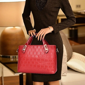 Chic red patent leather handbag with chain embossed pattern and stylish metal handles