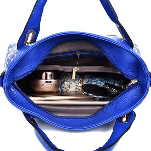 Royal blue tote bag with embossed chain texture showing spacious interior and pockets