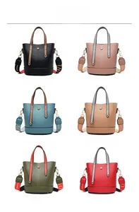 Detail showing various colors of bucket bags with colorful LOVE letter straps