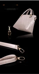 Close-up of beige quilted leather handbag with gold metal hardware and detachable strap