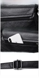 Détails d'un sac en cuir noir grainé montrant les coutures et la boucle en métal