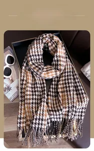 Chic winter scarf featuring classic houndstooth pattern and soft fringe detail