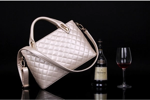 Detail of champagne gold quilted handbag with premium leather texture and metal hooks