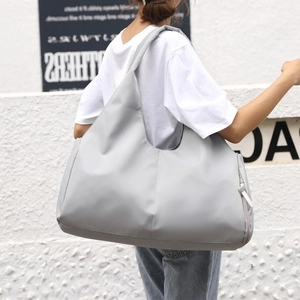 Light gray large sports gym bag with shoe compartment and waterproof fabric shown on model