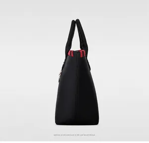Side view of black 5-piece handbag set with red stitching and trapezoidal structure